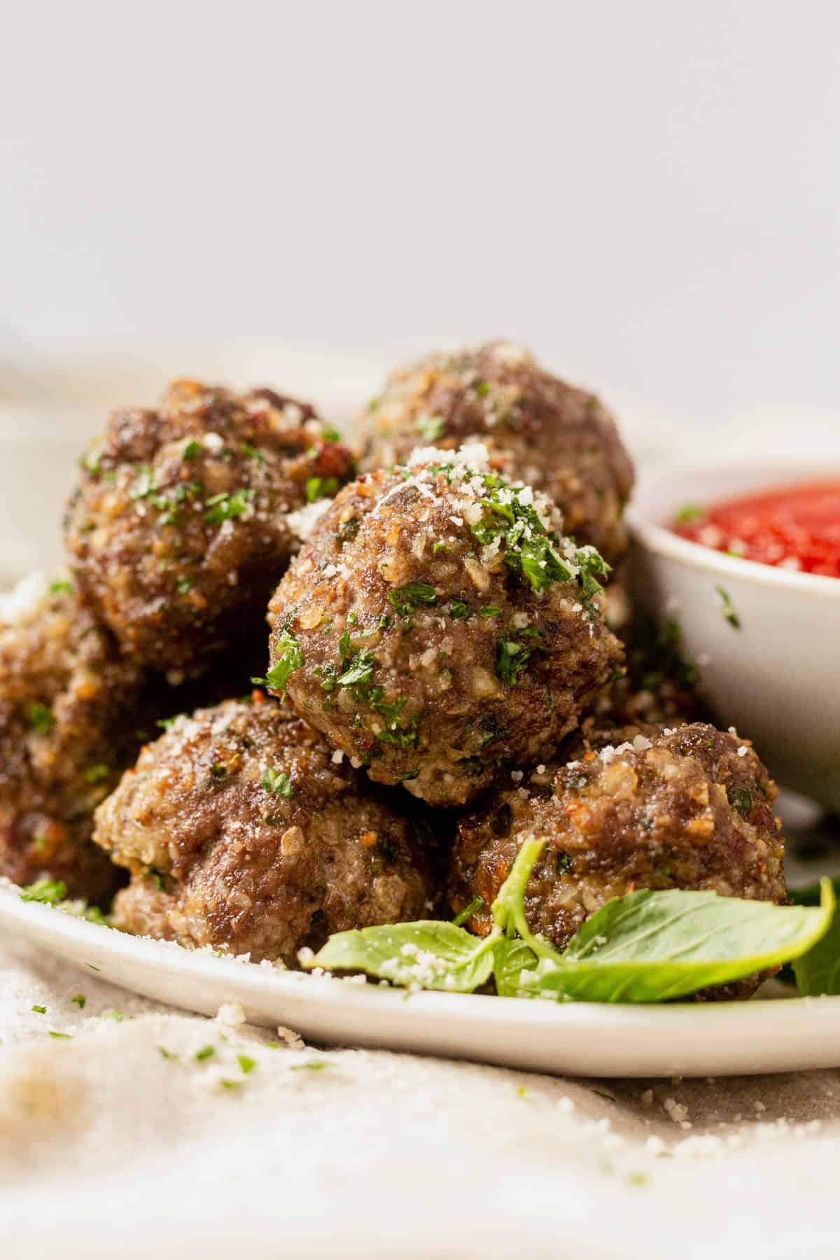 a plate of air fryer meatballs with parsley and parmesan cheese