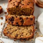 loaf of oat flour banana bread with the first couple of slices cut into