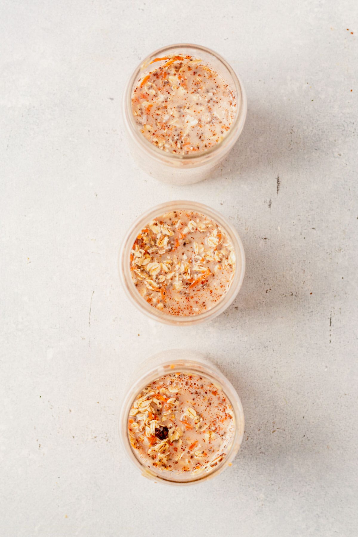 carrot cake overnight oats mixed in jars before refrigerating.