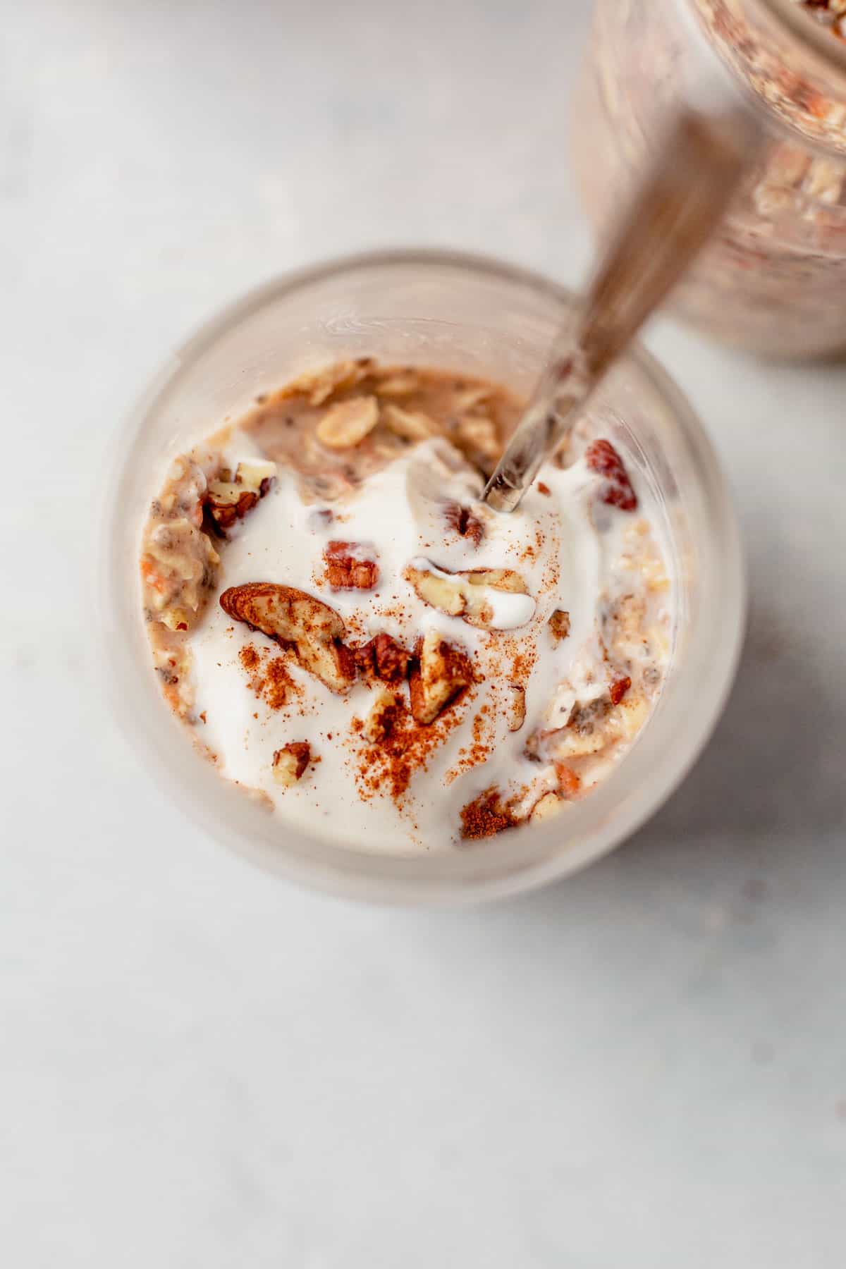 a spoon inside a jar of overnight oats