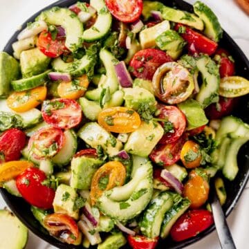 cucumber tomato avocado salad in a serving bowl