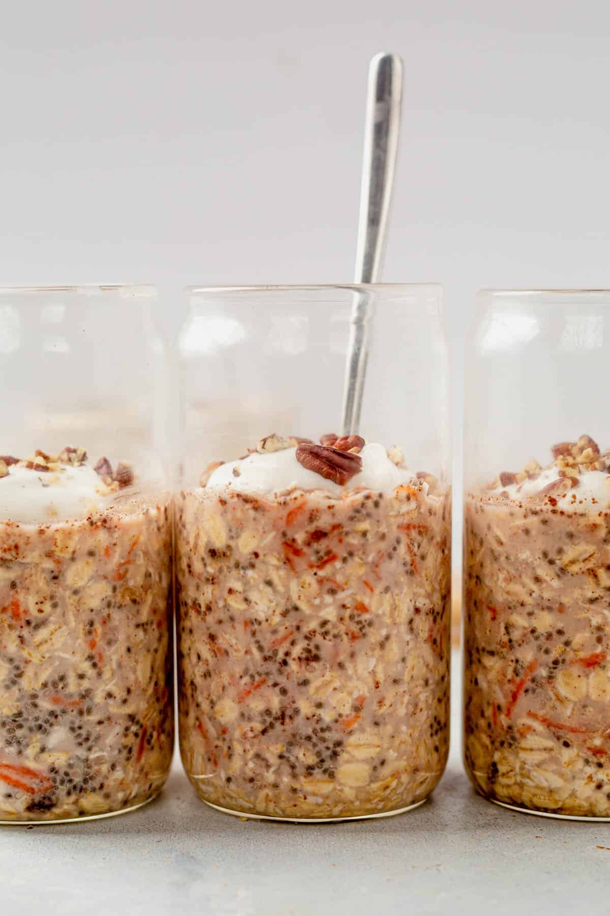 three jars of carrot cake overnight oats in a row