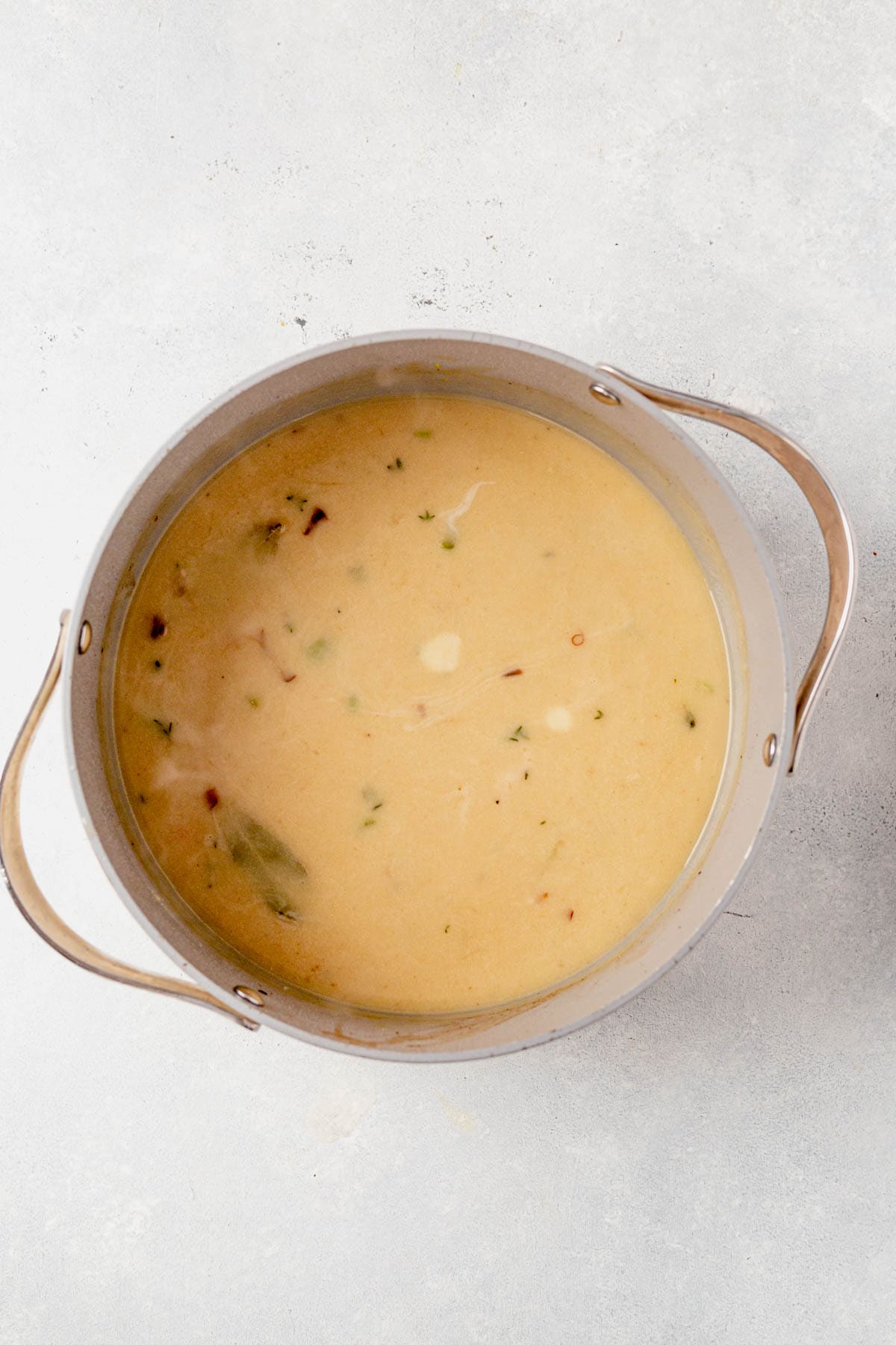 creamy chicken soup base simmering in a large pot