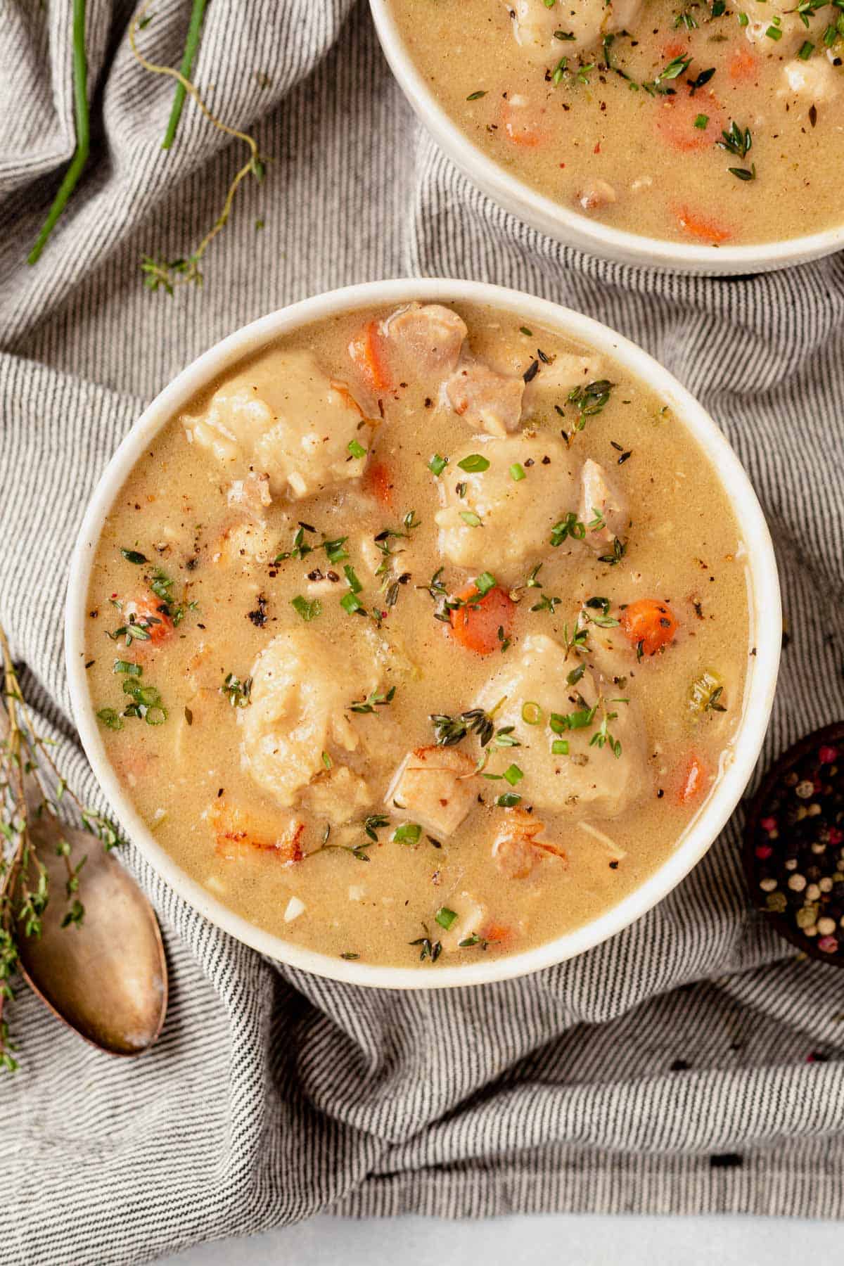 gluten-free chicken and dumplings in a large white serving bowl