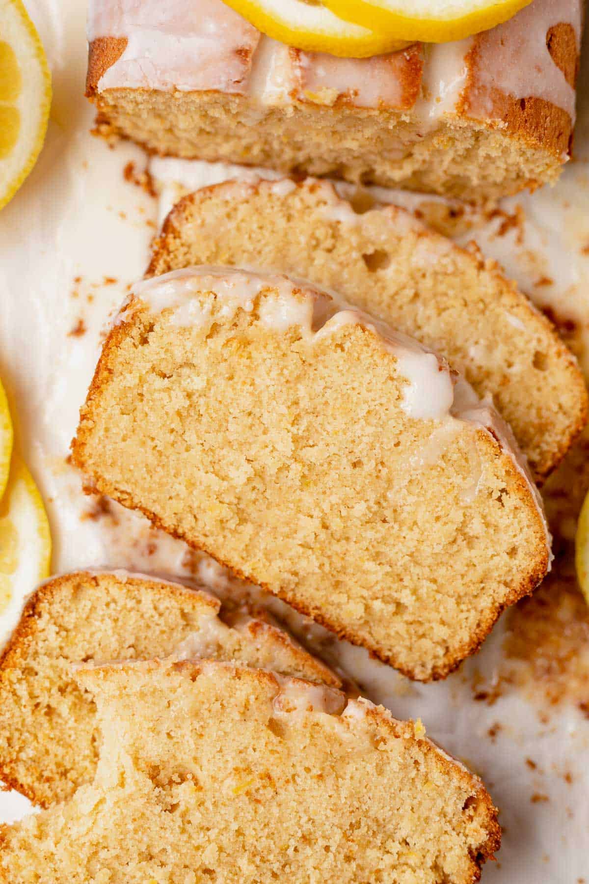 4 slices of gluten-free lemon drizzle cake on parchment paper