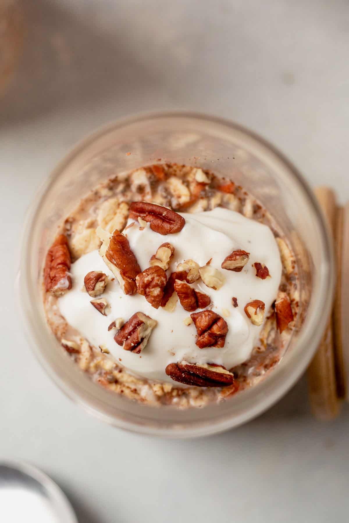 greek yogurt with chopped pecans on top of overnight oats