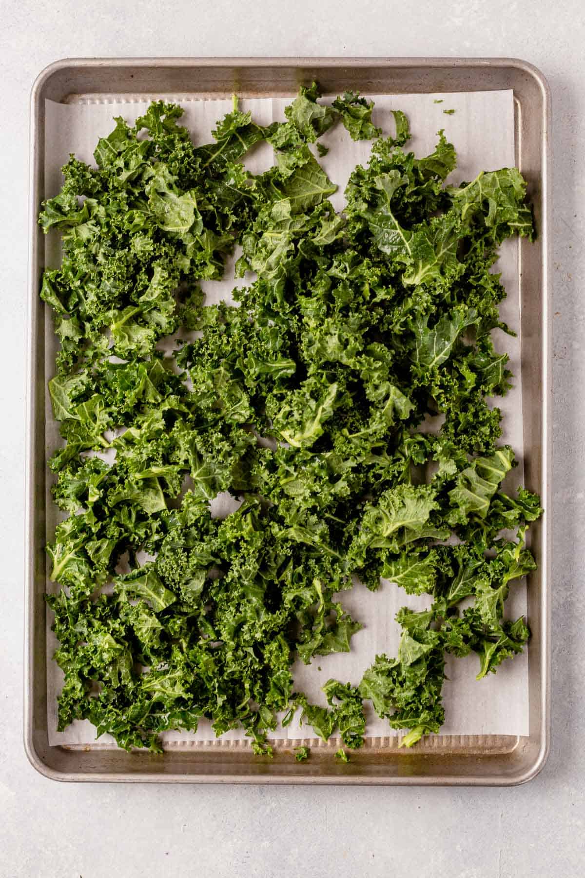 raw frozen kale on a baking sheet