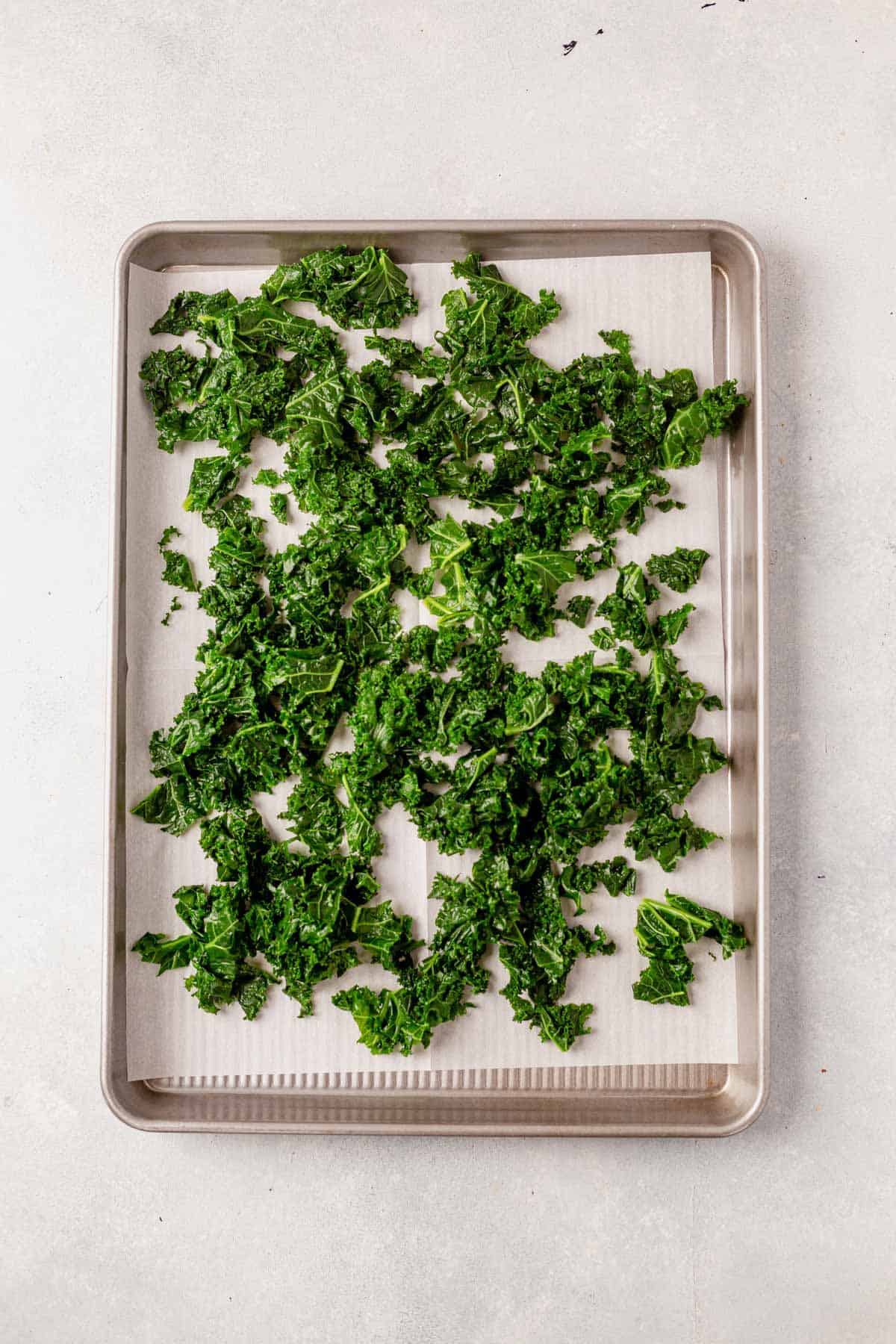 blanched and frozen kale on a baking sheet