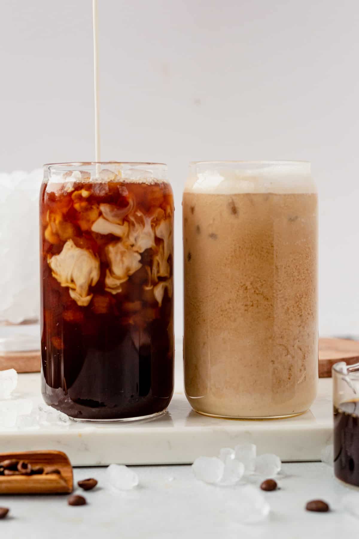 pouring cream into an iced coffee