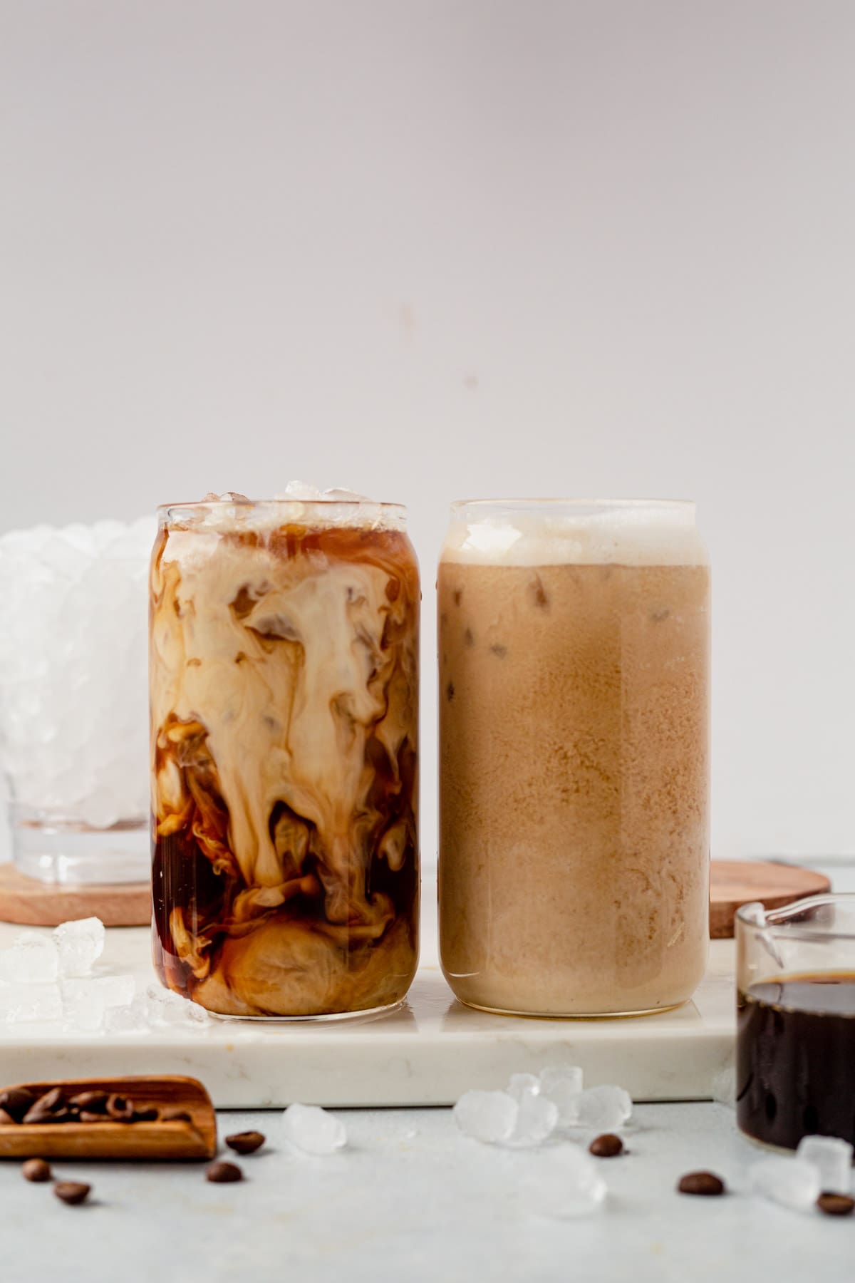 an iced latte and an iced coffee on a countertop
