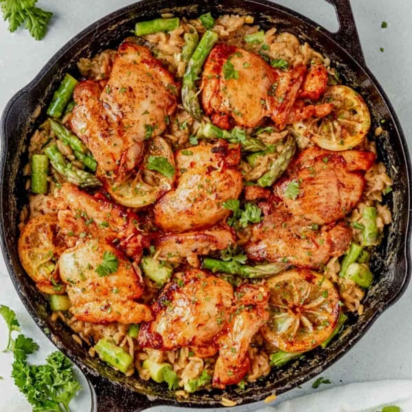 creamy lemon orzo chicken in a cast iron skillet.