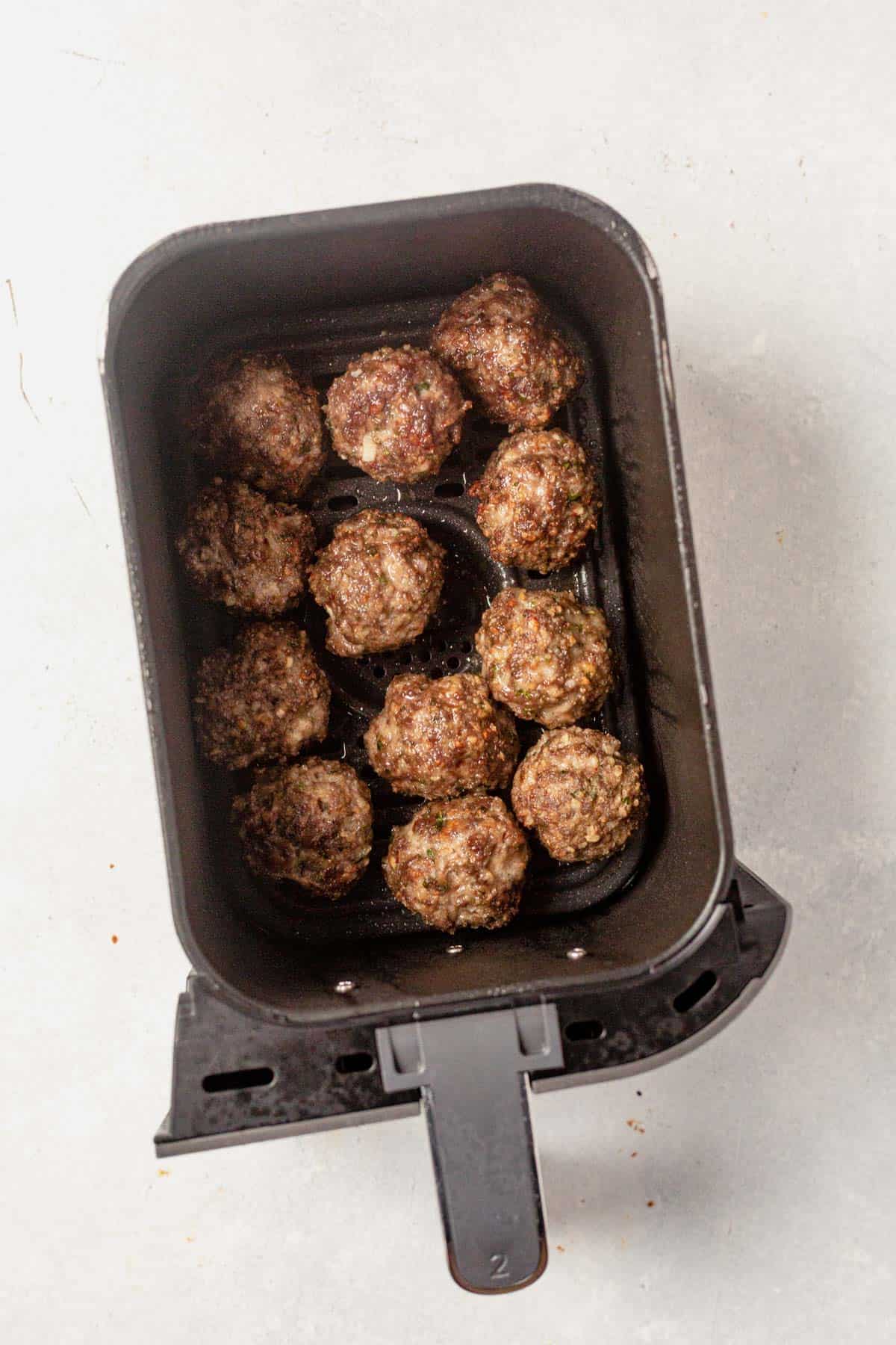 cooked meatballs in the air fryer basket