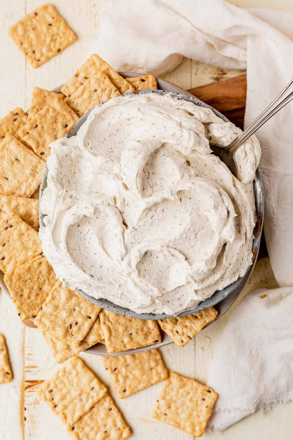 a bowl of homemade boursin cheese served with crackers