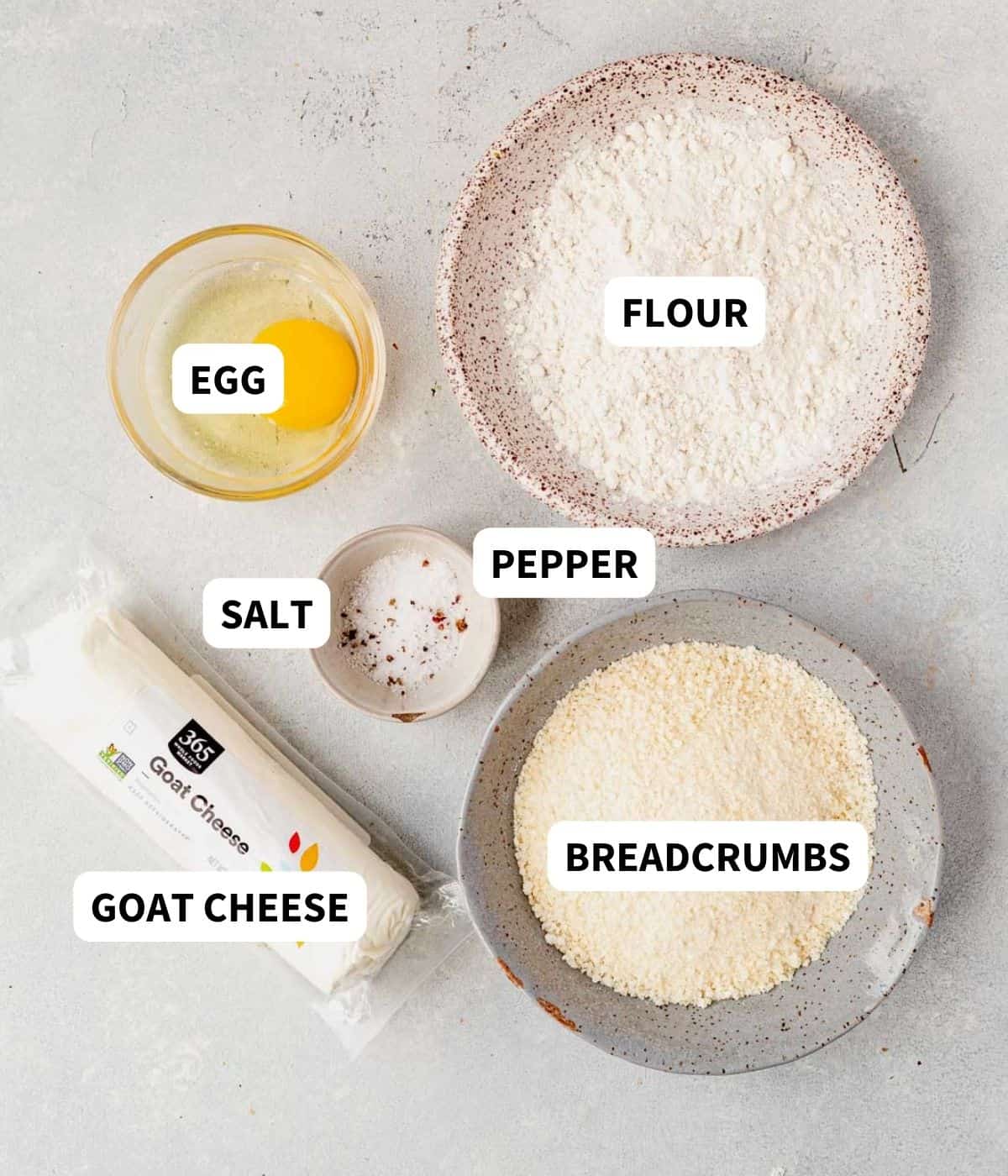 goat cheese, flour, egg, salt, and breadcrumbs on a countertop