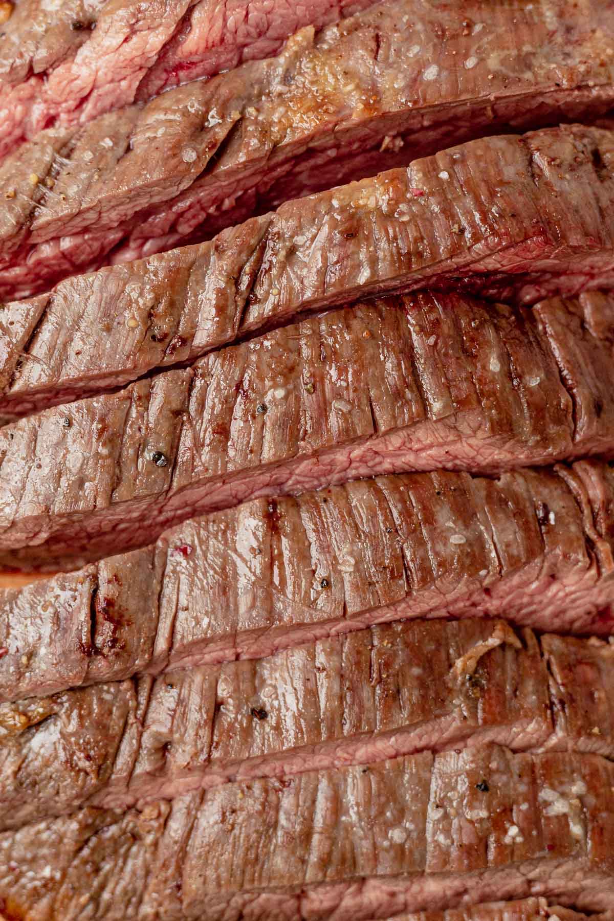 sliced flank steak cooked to medium rare
