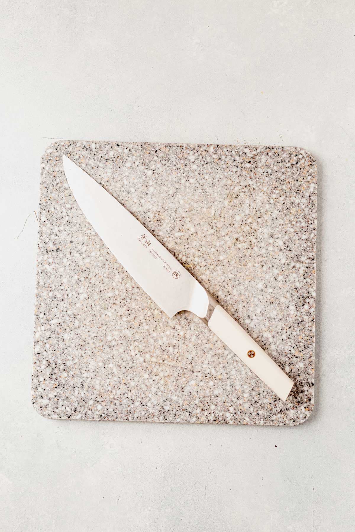 cutting board and sharp knife on a countertop