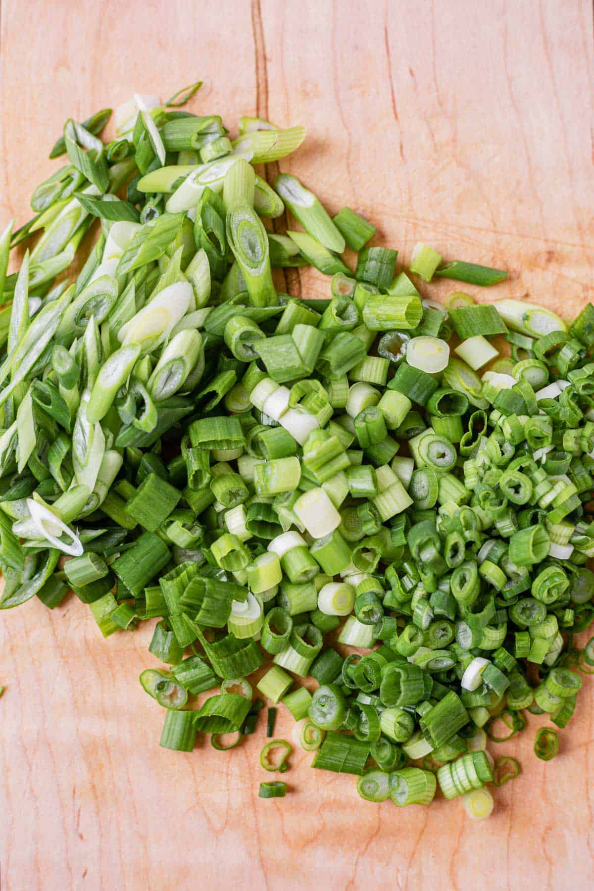 green onions cut into small pieces and cut on the bias on a cutting board
