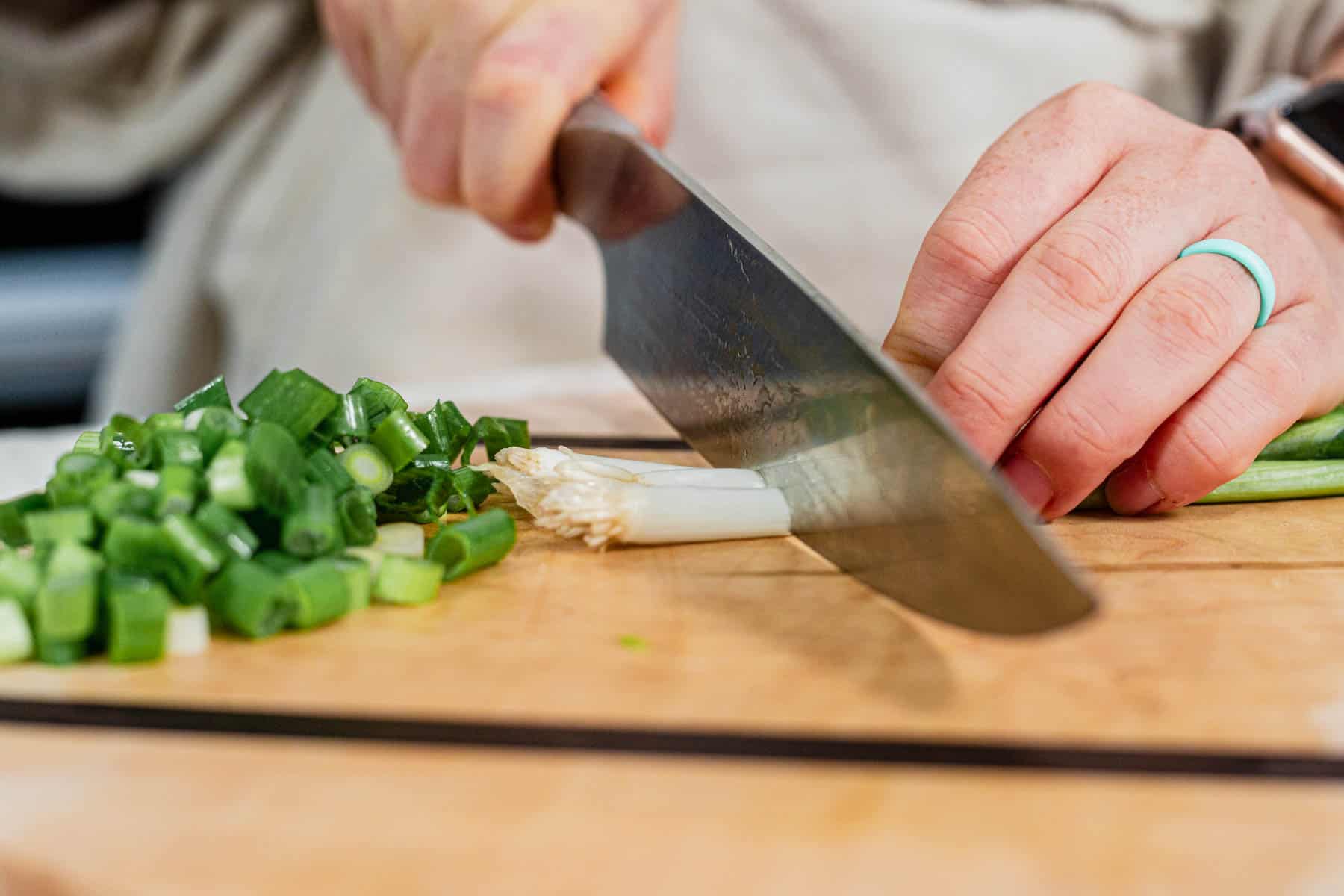 cutting the roots off of green onions