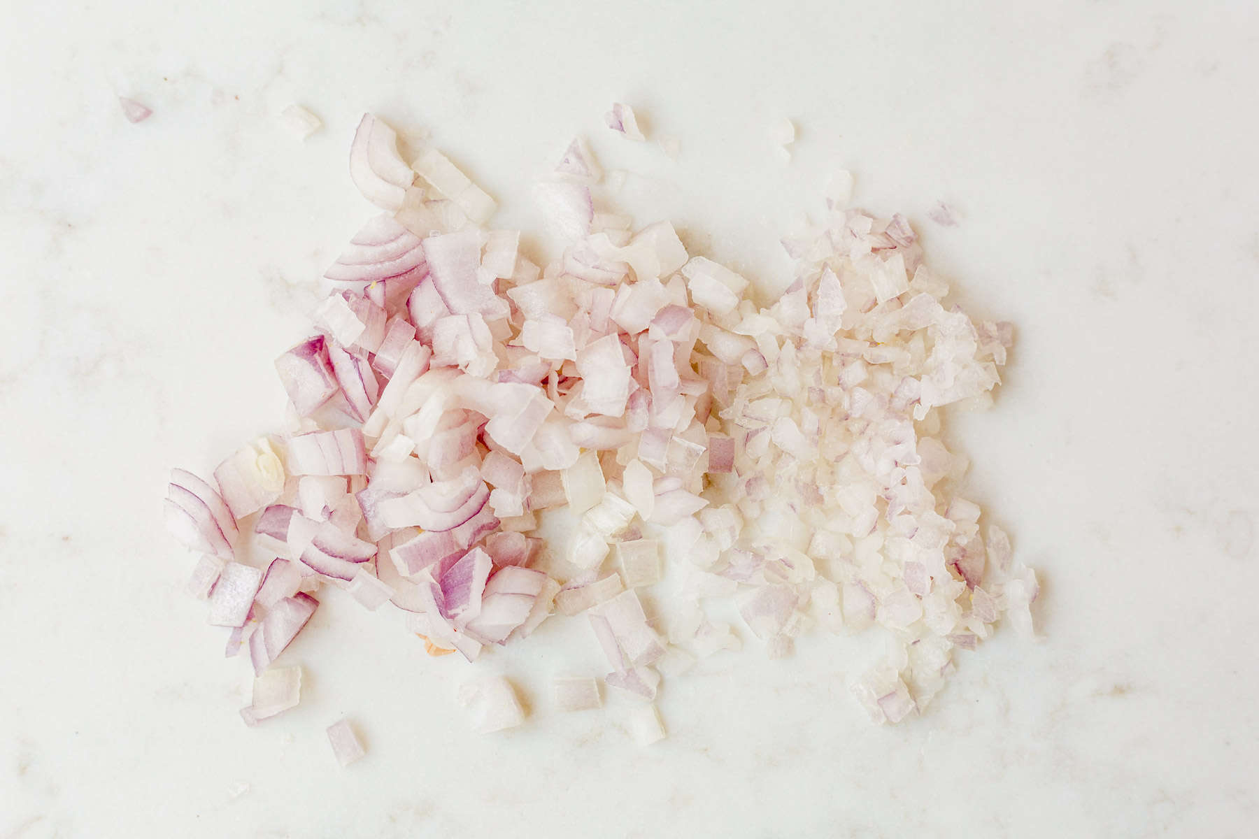 diced and minced shallots on a cutting board