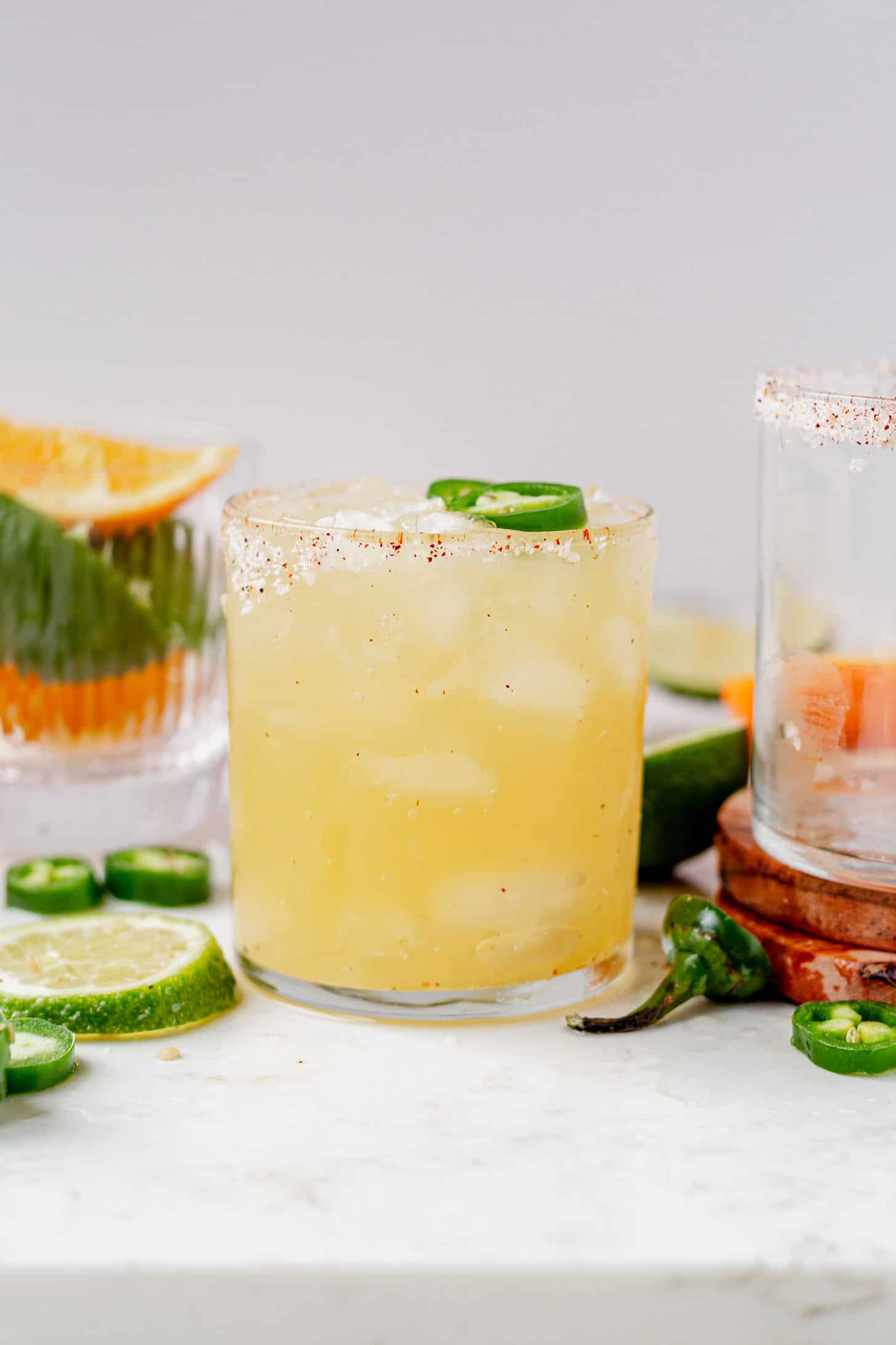 skinny spicy margarita with jalapeno on a marble serving tray