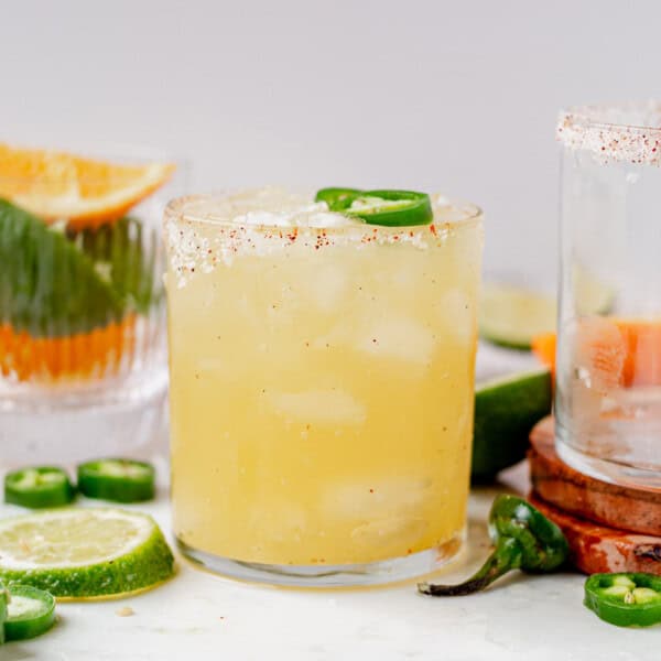 a skinny spicy margarita with tajin rim on a marble countertop