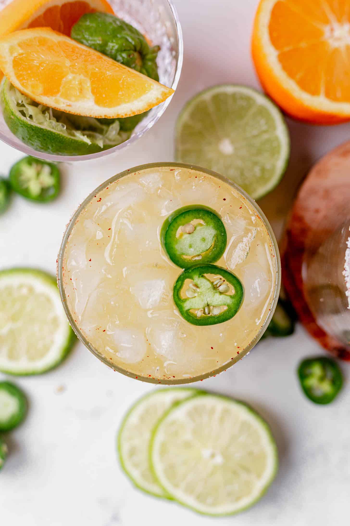 two jalapeno slices on top of a skiny spicy margarita