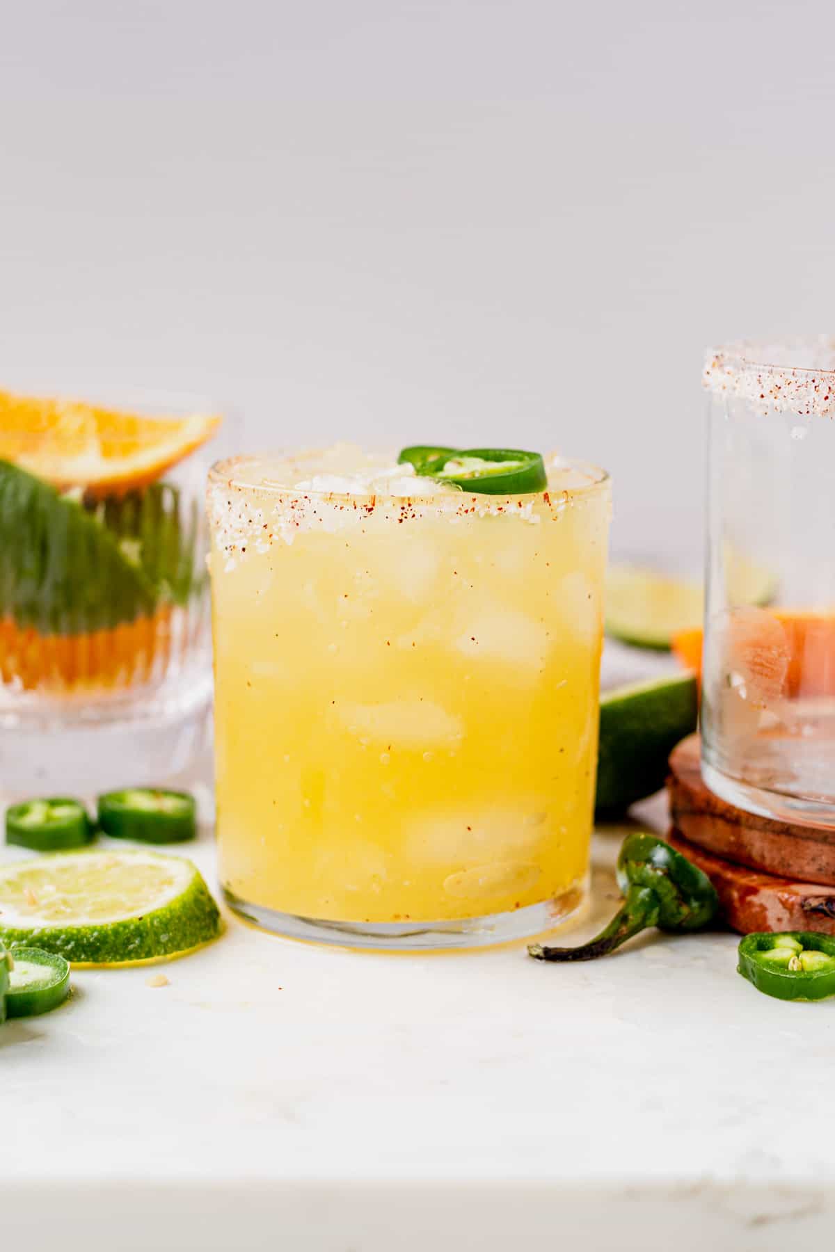 skinny spicy margarita recipe in a glass with slice jalapeño on top