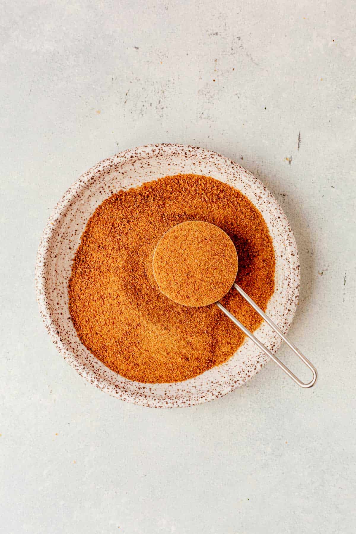 a bowl of coconut sugar with a measuring cup