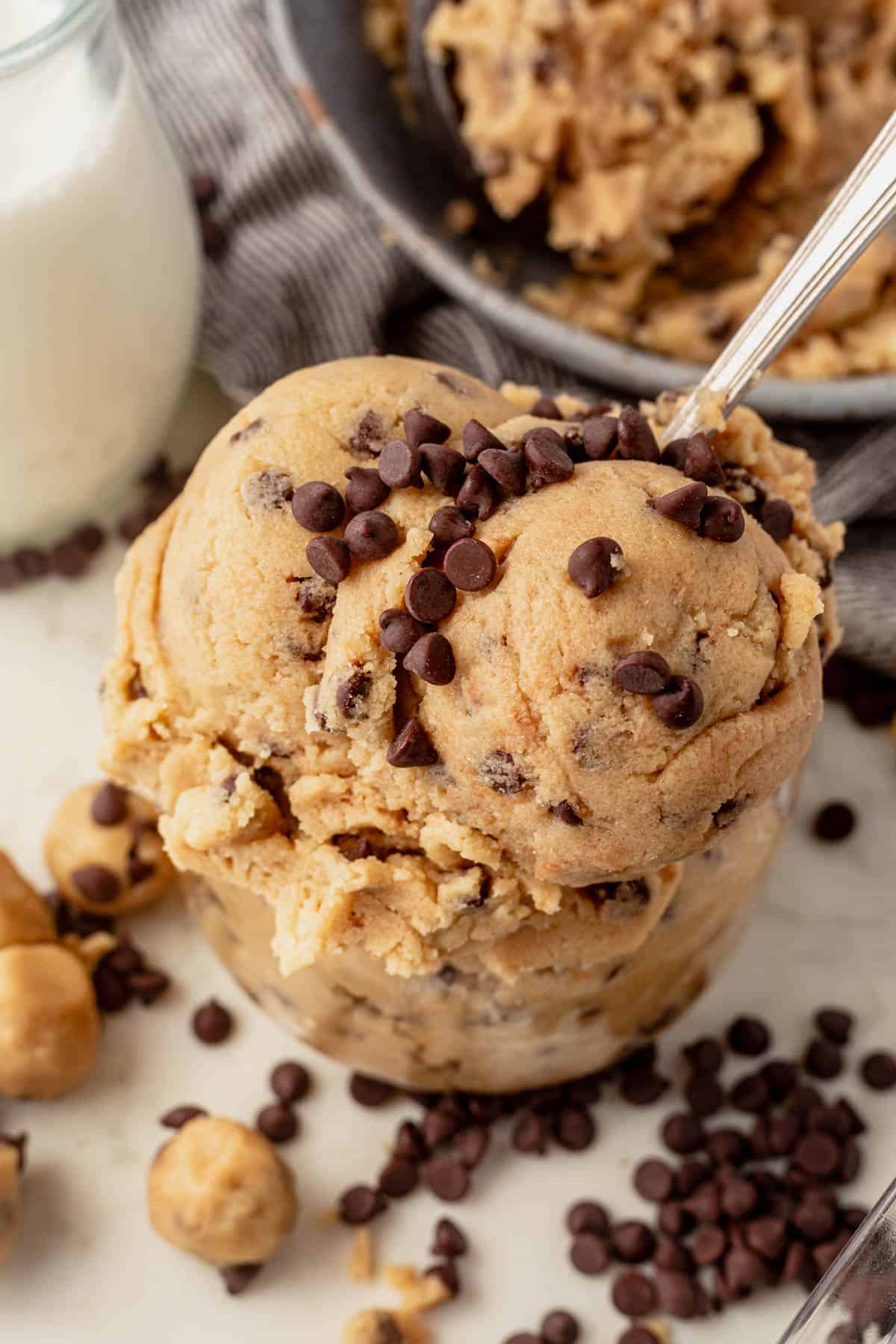 two scoops of edible cookie dough in a glass bowl