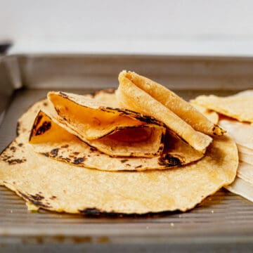 softened corn tortillas on a tray