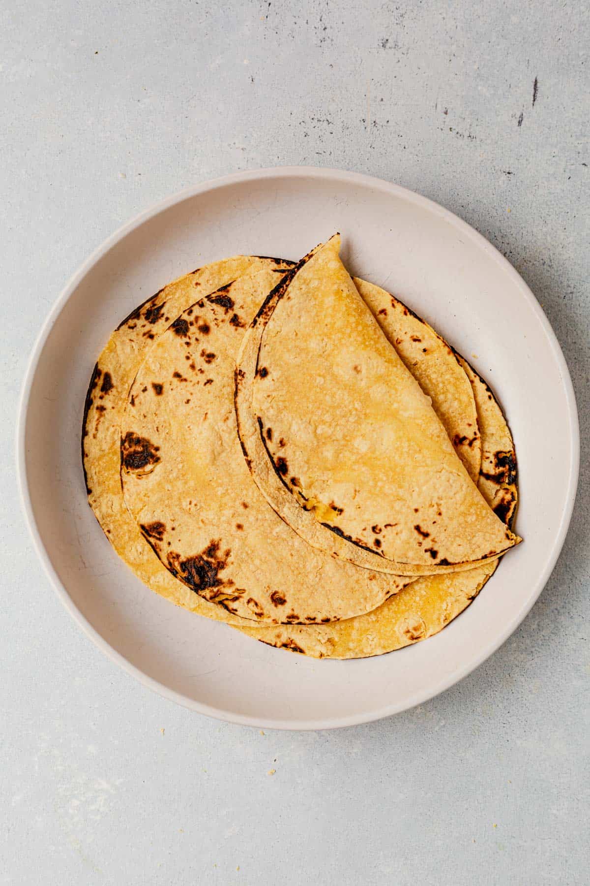 charred corn tortillas on a plate