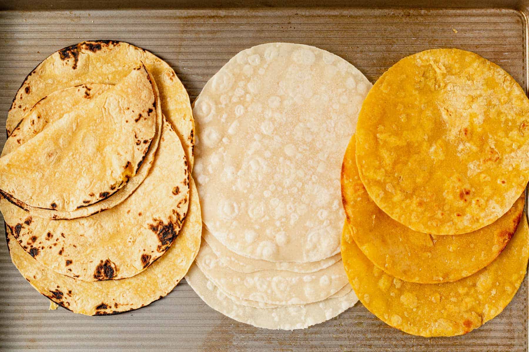 softened tortillas on a baking sheet