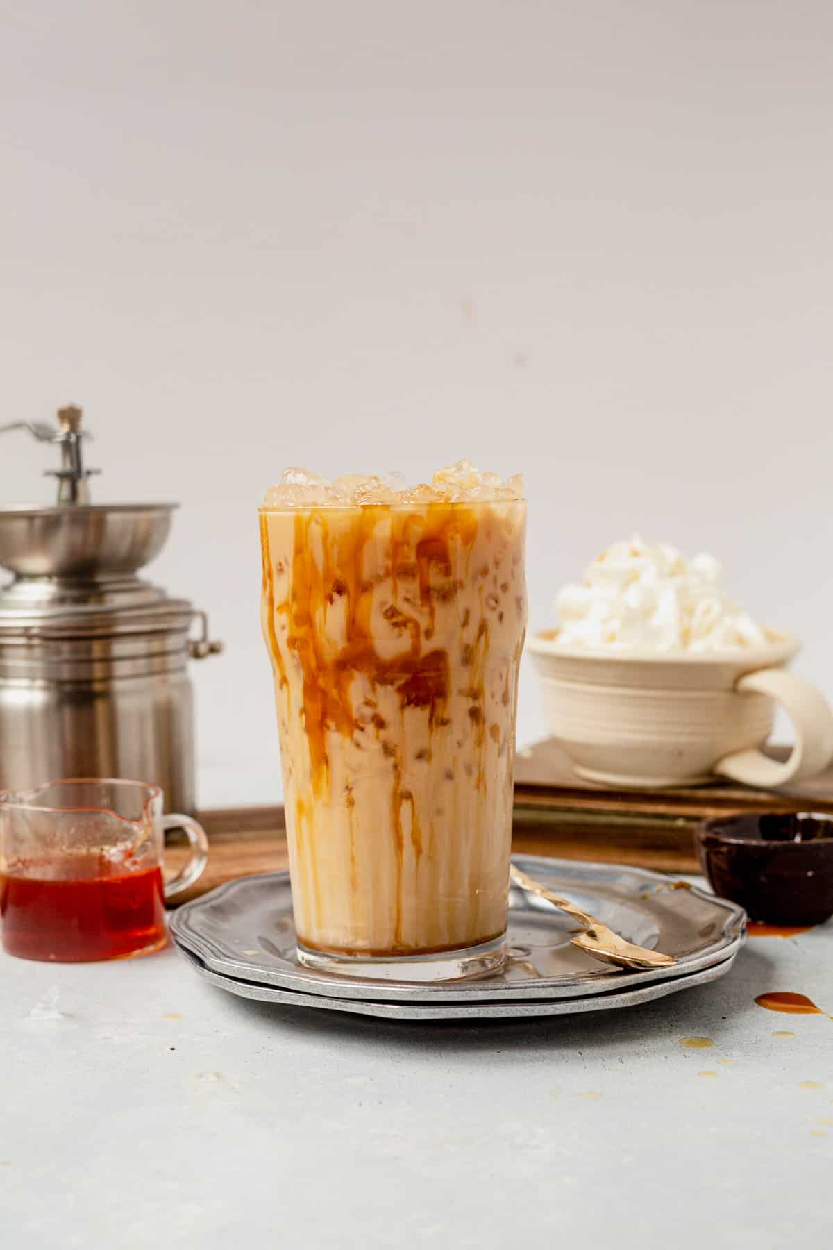 iced caramel latte in a glass with caramel sauce on top
