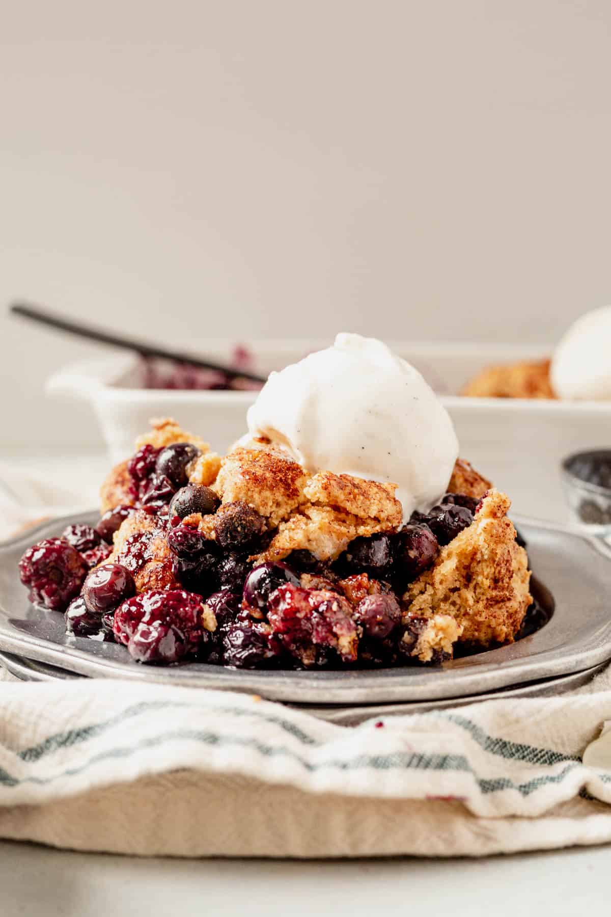 gluten free blueberry cobbler on a plate with ice cream