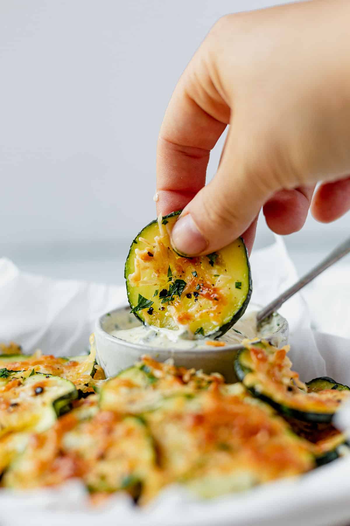 air fryer zucchini chip dipped in ranch