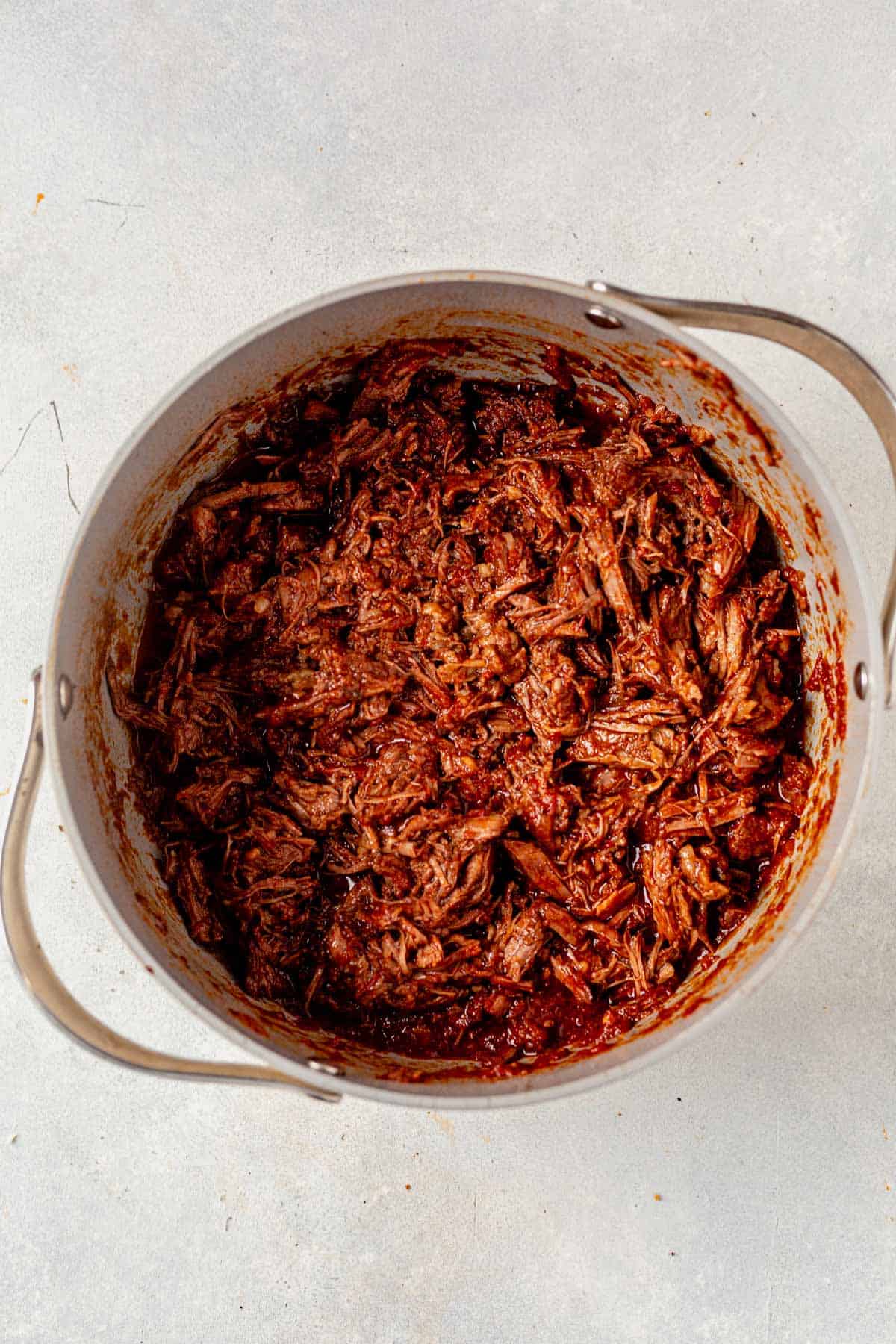 shredded beef in a stock pot