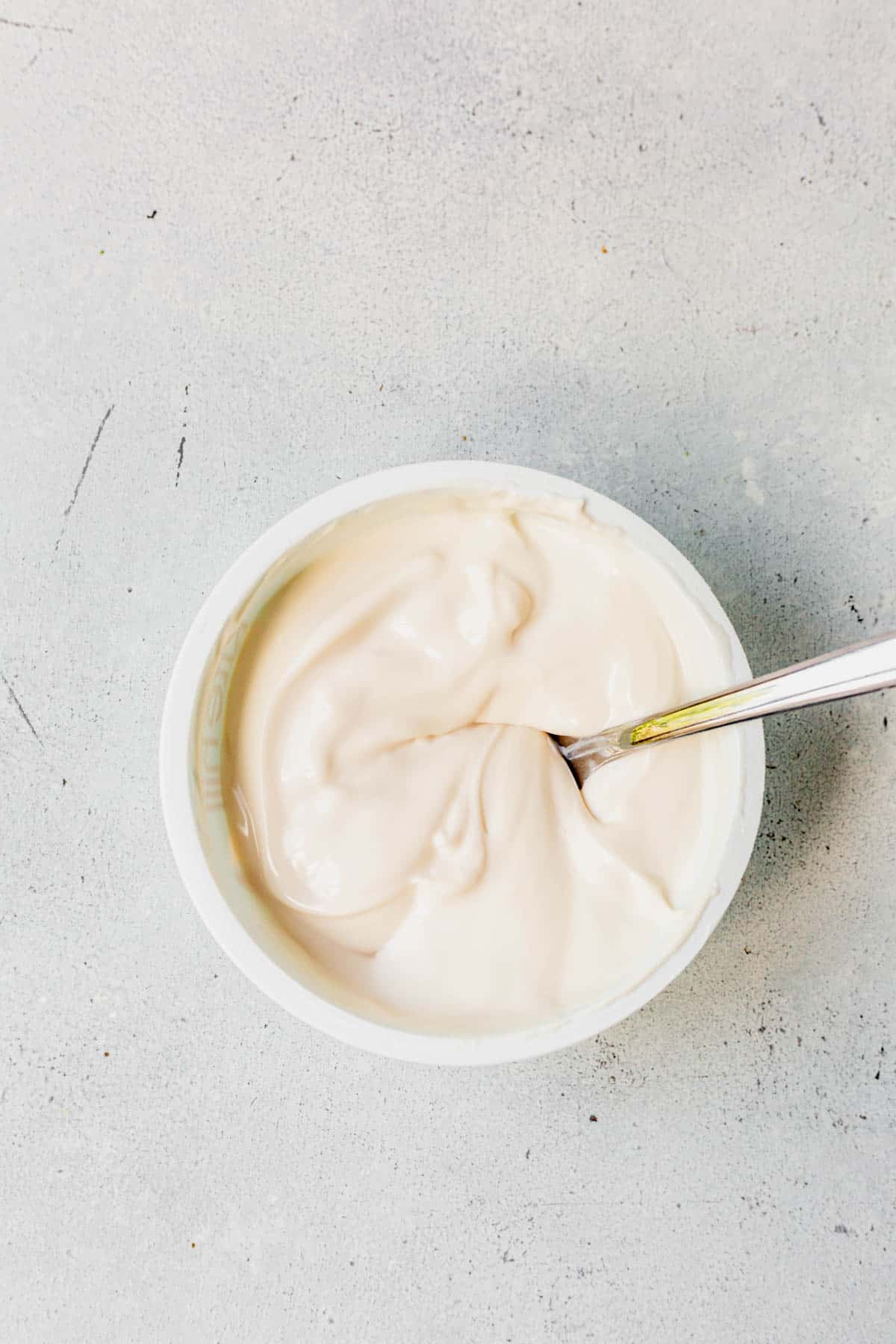 sour cream in a bowl with a spoon