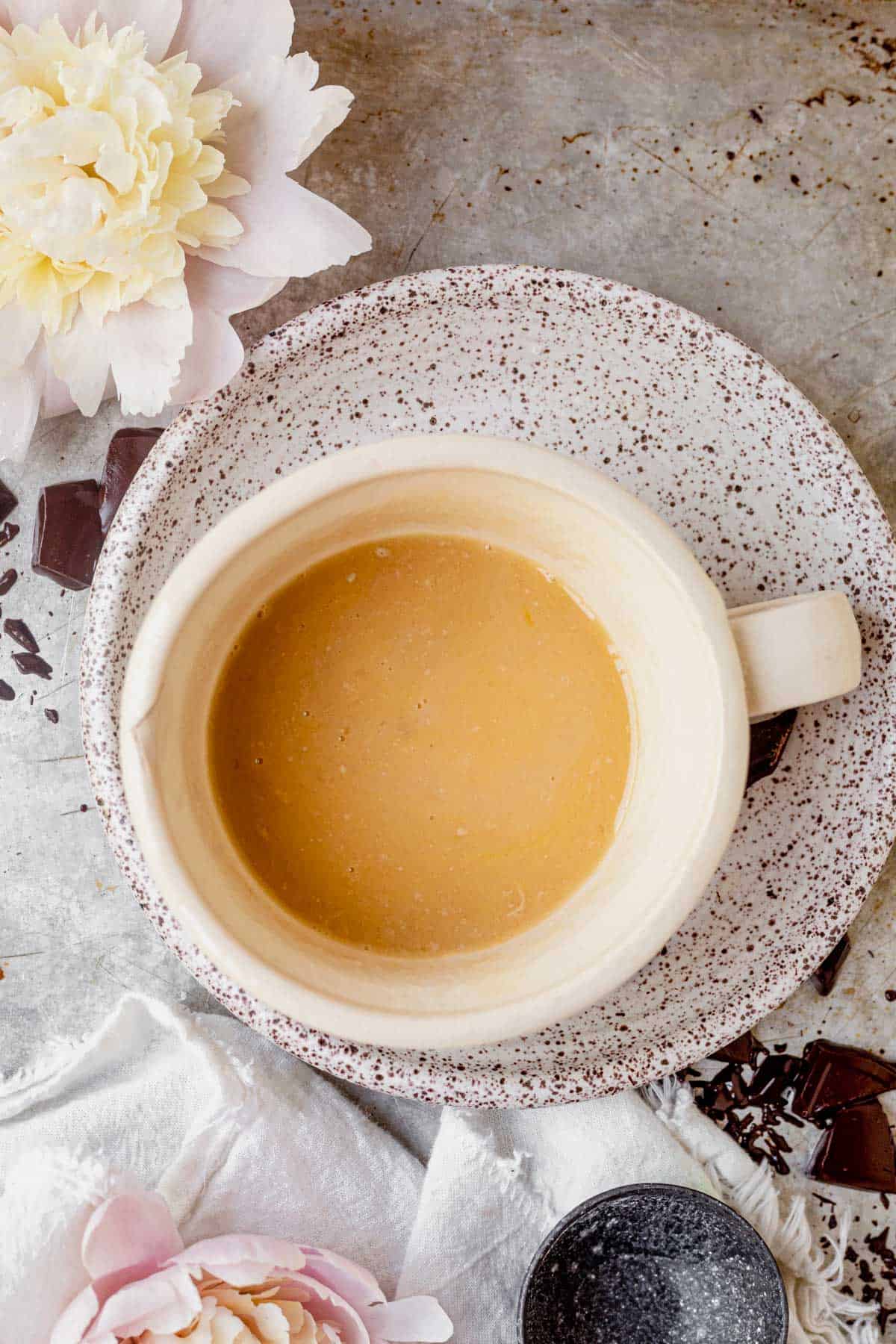 wet ingredients for chocolate chip cake in a coffee mug