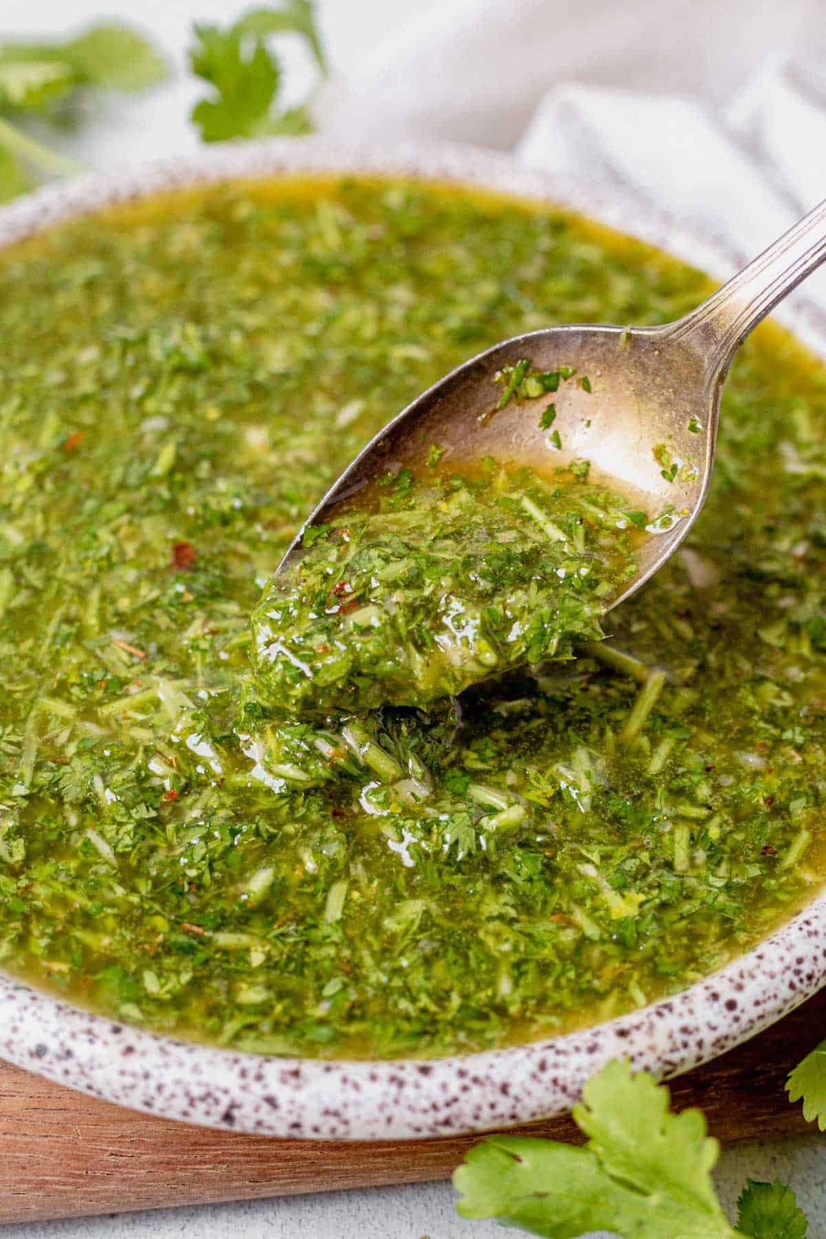 cilantro chimichurri in a bowl with a spoon