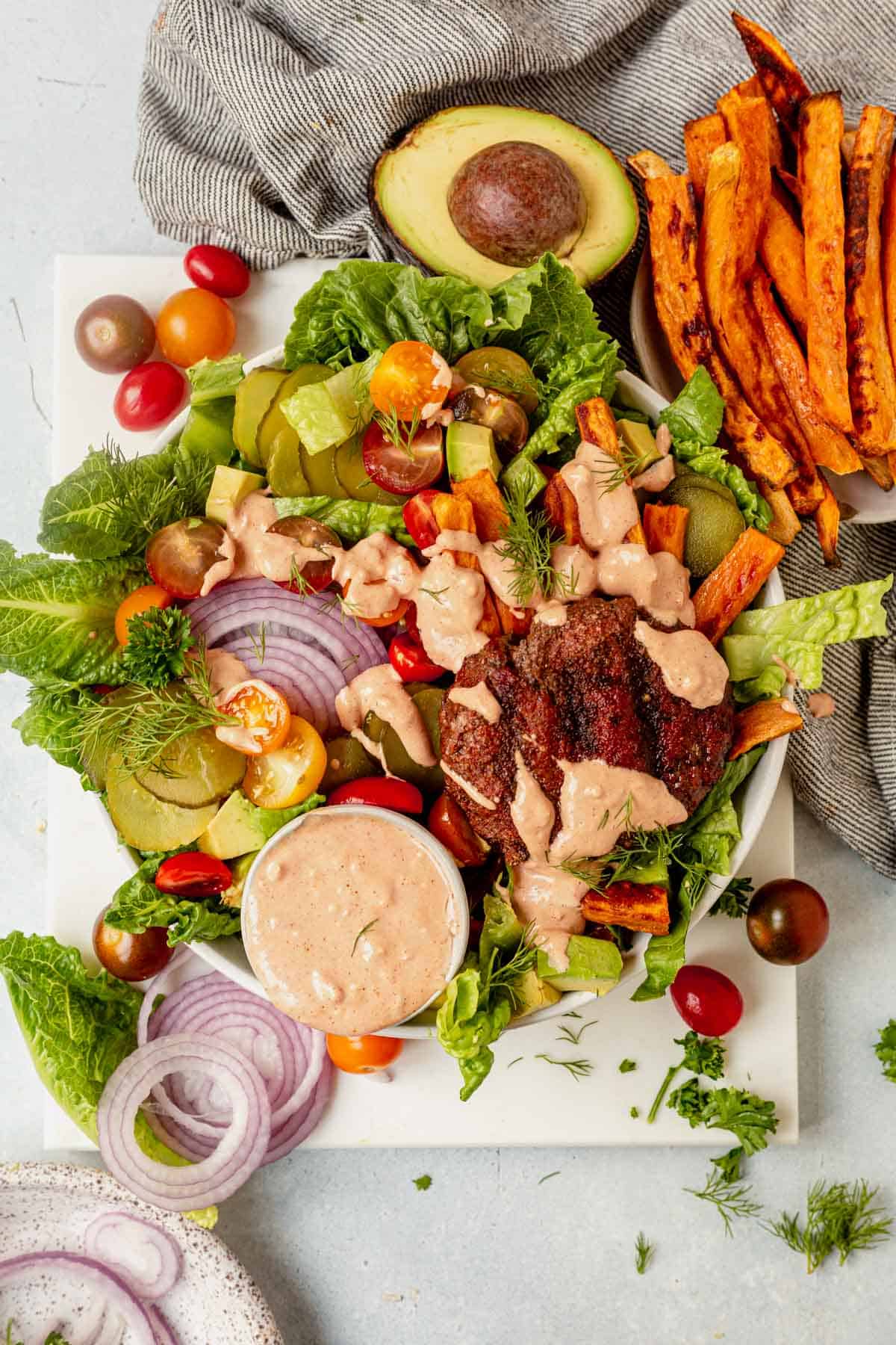 grilled burger bowl with sweet potato fries and sauce