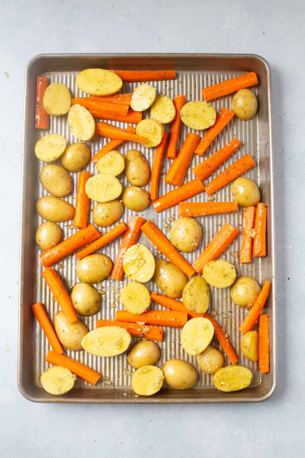 potatoes and carrots on a sheet pan