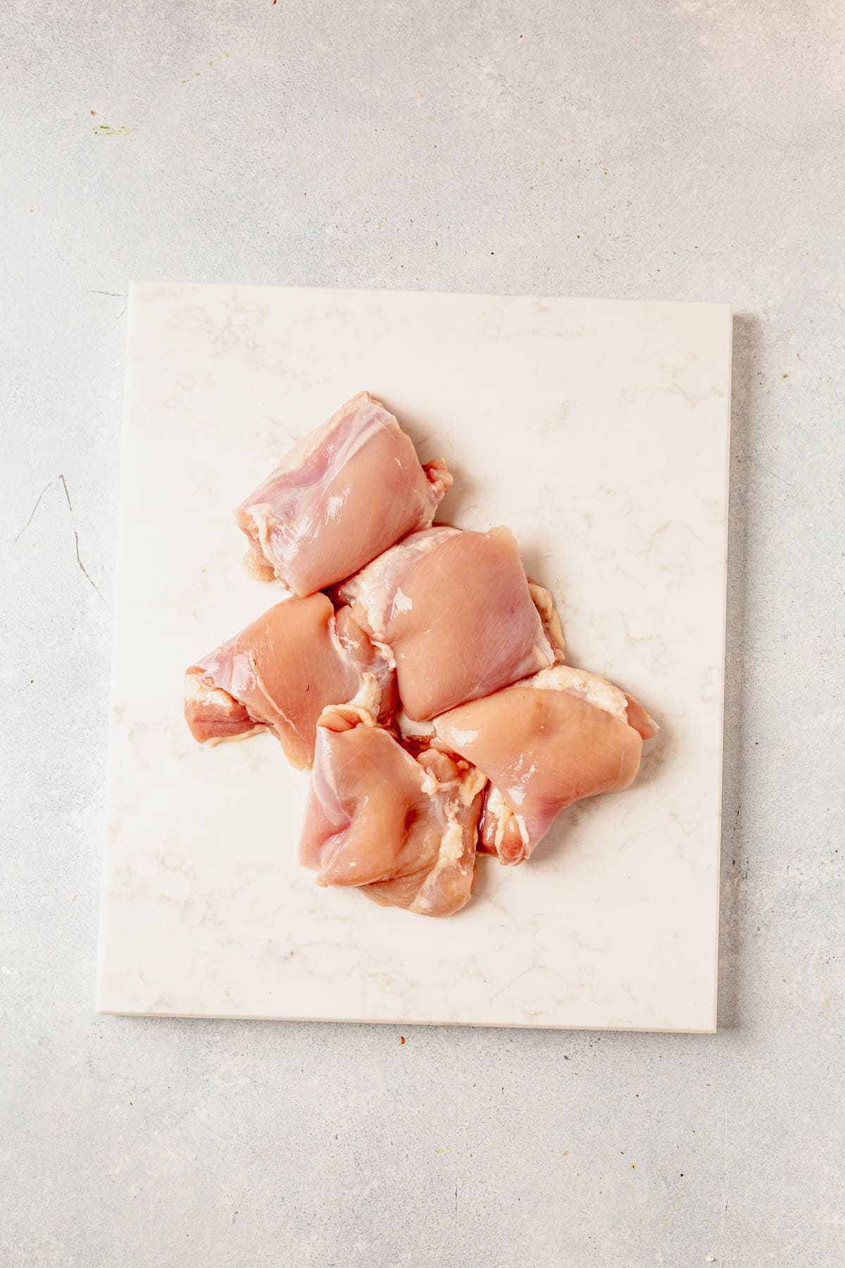 raw chicken thighs on a cutting board