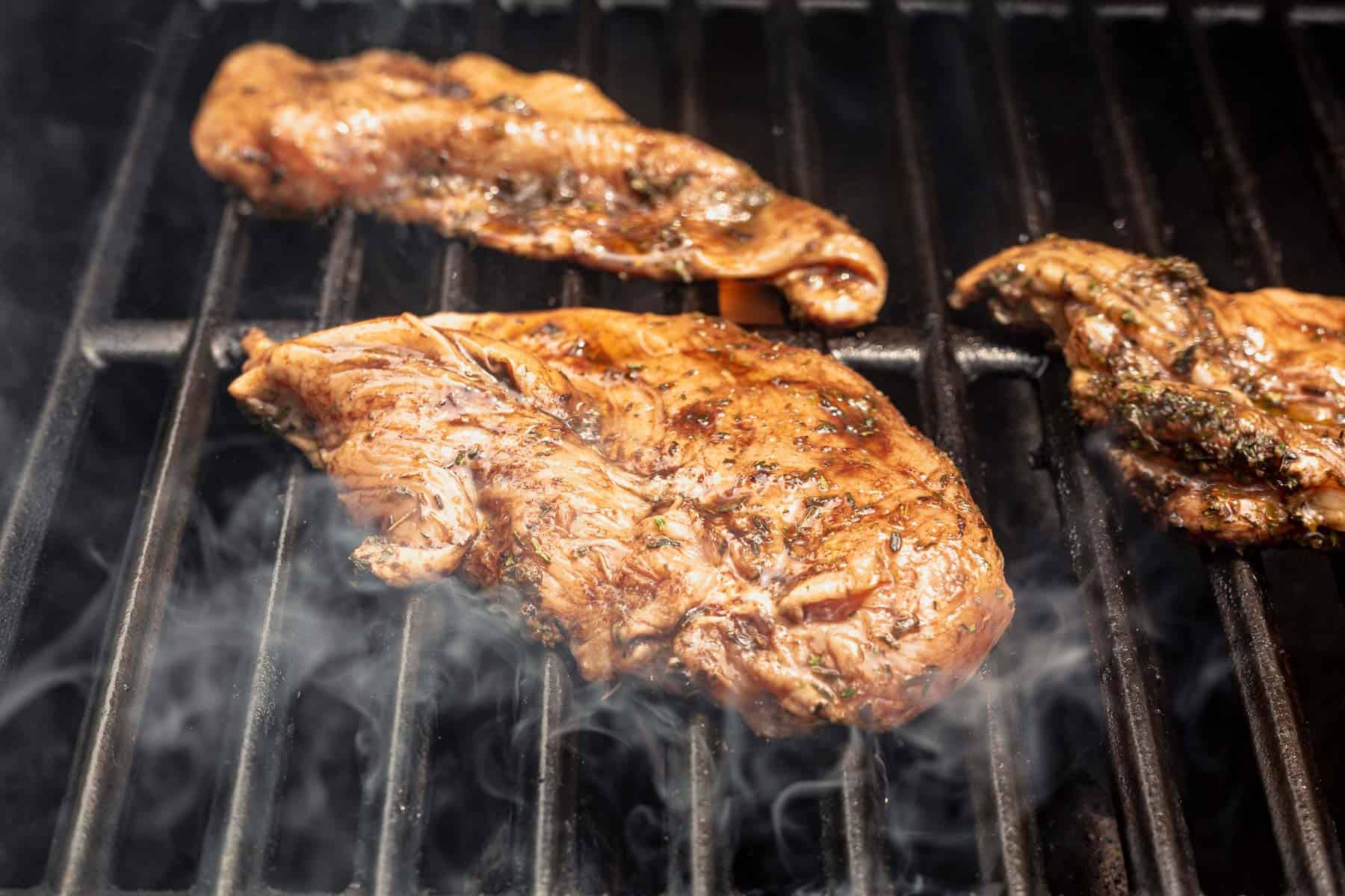 boneless chicken breasts on a gas grill.