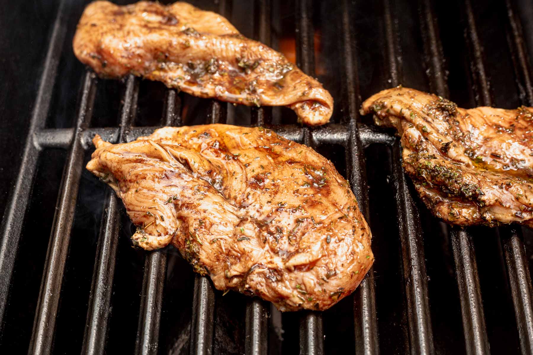 raw chicken on the grill grates
