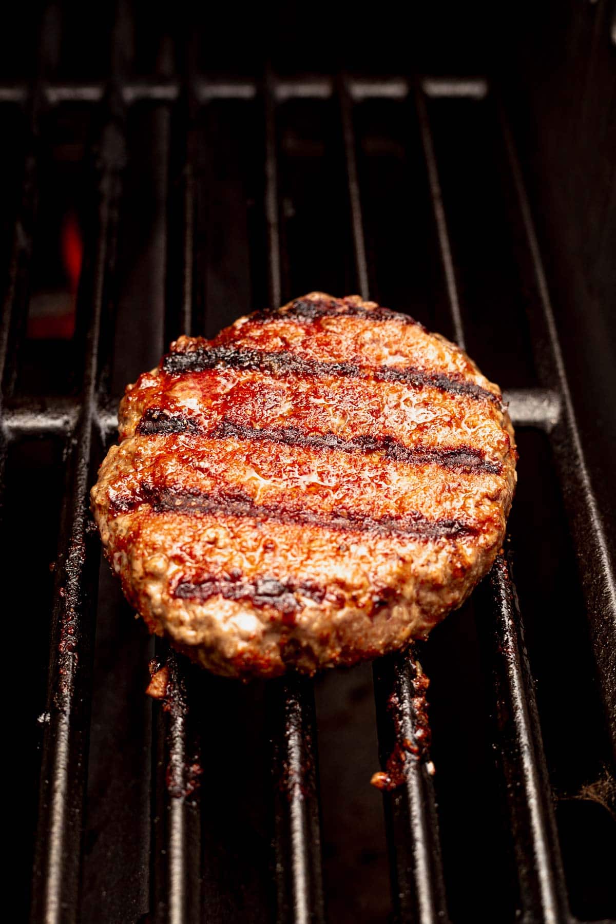 burger patty on hot grill grates