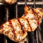 boneless chicken thighs with grill marks on a grill