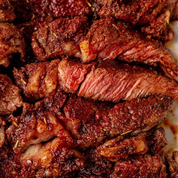 grilled and sliced medium-rare ribeye steak on a plate
