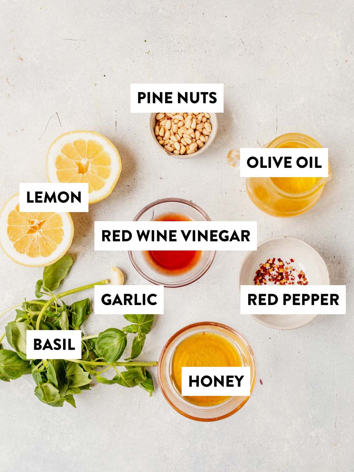 ingredients for salad dressing portion of lemon basil orzo salad laid out on a counter and labeled