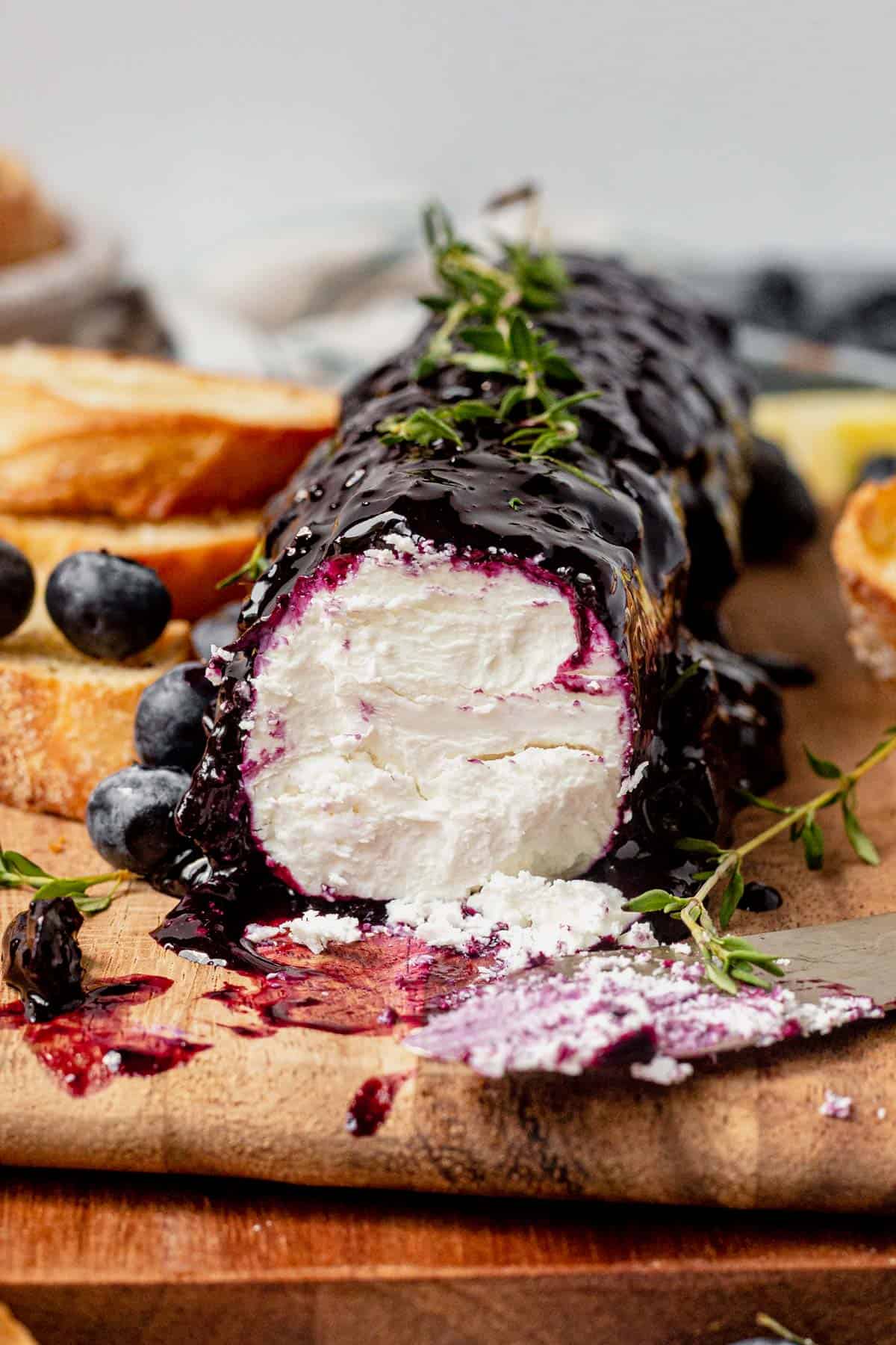 blueberry goat cheese on a wood cutting board
