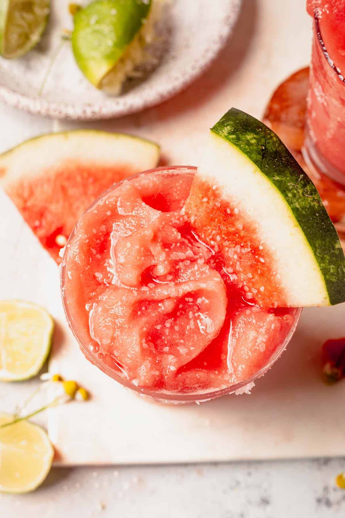 watermelon wedge in a glass of frozen watermelon margarita